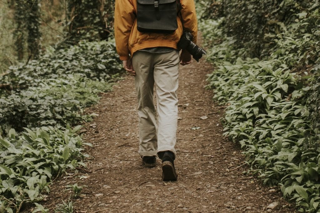 man-walking-through-woods